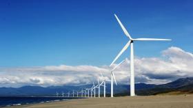 https://www.pexels.com/it-it/foto/turbine-eoliche-bianche-sulla-sabbia-grigia-vicino-al-corpo-d-acqua-3976320/